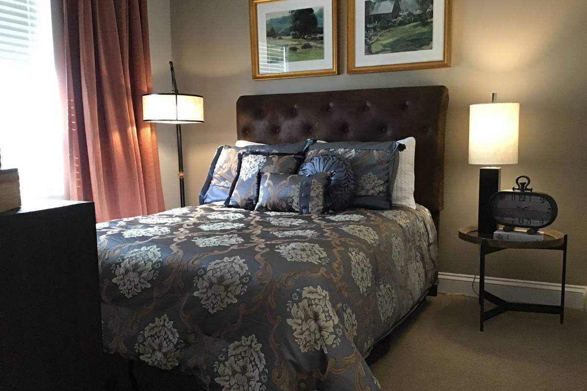 Private bedroom decorated with lamps and throw pillows