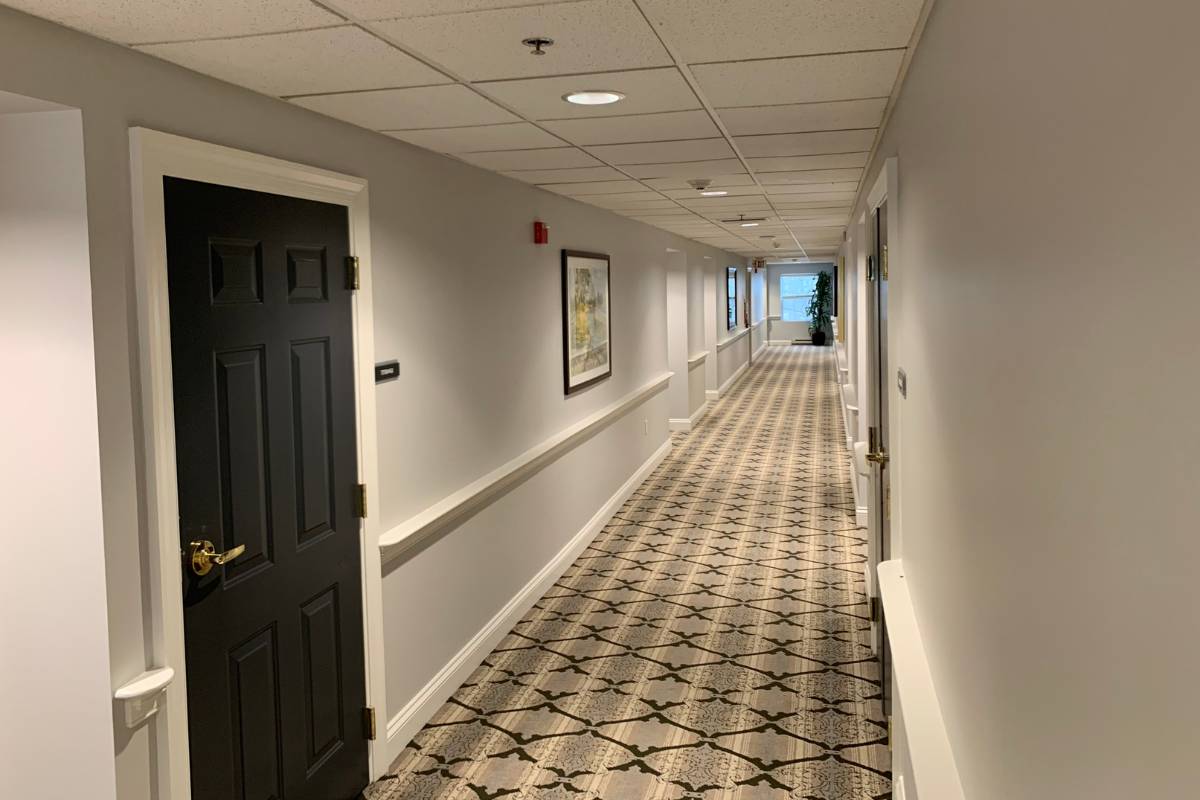 Corridor hall at Dresher Estates with a patterned floor and doorways
