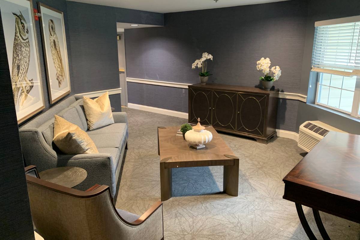 The Serenade lounge at Dresher Estates, a secluded room with a chair and sofa