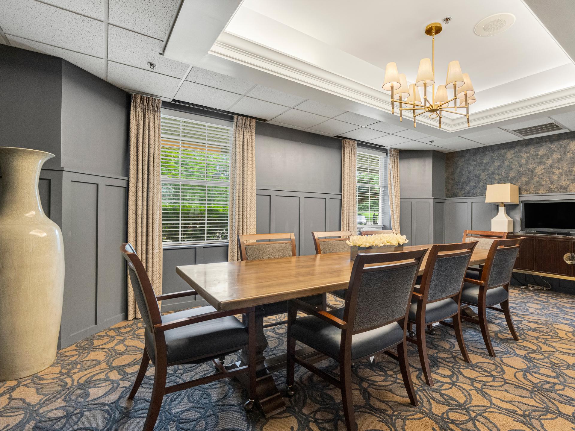 Private Dining room at Dresher Estates, with mirrors decorating the wall, and a long tables for plenty of seating.