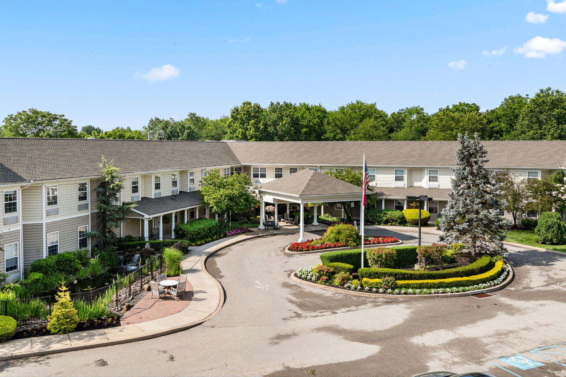 DresherEstatesHome Main parlor at Dresher Estates with console tables, couches, and chairs around a fireplace.